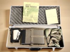 A portable magnetometer, in case with instructions.