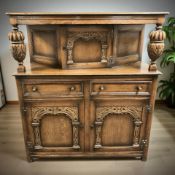 A reproduction carved oak buffet sideboard, 123 cm x 53 cm x 137 cm.