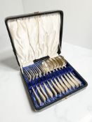 A cased set of silver dessert spoon and forks, six place setting, London 1909.