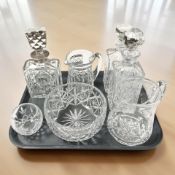 A crystal decanter with silver collar, two further decanters,