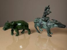 A carved malachite figure of a water buffalo and a further oriental patinated metal figure of a man