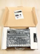 An Arturia Drumbrute analog drum synthesizer, in box with power lead and user guide.
