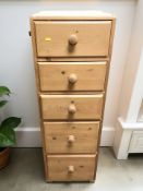 A reproduction pine five drawer pedestal,