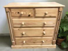 A modern pine five drawer chest,