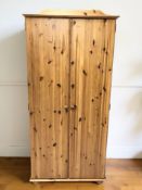 A modern pine double door wardrobe, 88 cm W x 55 cm D x 183 cm H.