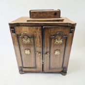 A Victorian oak double door smoker's cabinet, height 32 cm.