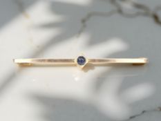 A gold sapphire bar brooch, width 48mm. CONDITION REPORT: 1.