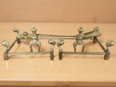 A pair of brass fire dogs, a companion set and a further pair of fire hearth corners.