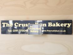 A reproduction two section advertising sign 'The Crusty Bun Bakery',