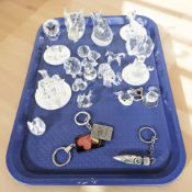 A group of crystal animal figures, paperweights, keyrings, costume earrings, etc.