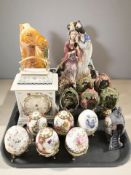 A Chinese Tang style pottery horse, a group of porcelain egg ornaments, mantel timepiece,