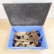 A group of antique wooden woodworking planes and other similar items.