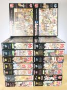 Sixteen Wasgij puzzles, some sealed in retail cellophane.