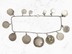 A silver coin bracelet with yellow metal clasp,