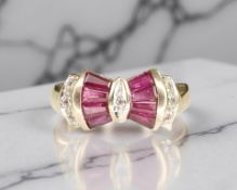 A 9ct gold ruby and diamond ring, the tapered-cut rubies forming a bow motif,