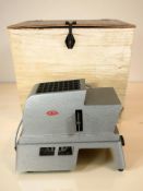 An Alphax III projector in case.