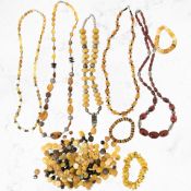 A group of costume bead necklaces, including a cherry Bakelite-coloured example,