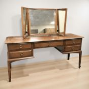 A Stag five drawer mirror back dressing table, 152 cm x 47 cm x 126 cm.