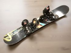 A snowboard and two pairs of goggles.