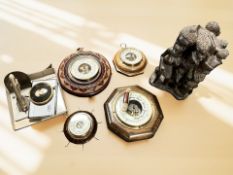 An African carved hardwood figure group and various barometers, Jaguar mascot bookend,