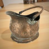 A Victorian copper coal helmet.