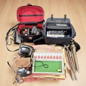 A group of vintage cameras, tripods and accessories,