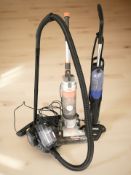 A Vax upright vacuum cleaner and two further vacuums.
