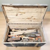 A painted pine box containing vintage tools and carpentry items.