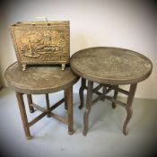 Two Islamic brass topped circular occasional tables and an embossed brass magazine rack.