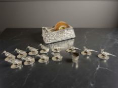A small silver bucket, three sets of four silver-plated menu stands in the form of snipe, pheasants,