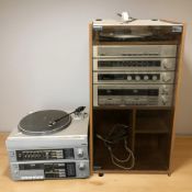 A smoked glass and teak effect hi-fi cabinet containing a BSR electronic belt drive system