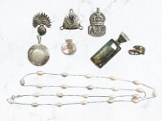 A silver locket, ARP badge, grenadiers badge, ring, two pendants, a pearl necklace,