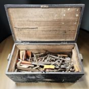 A painted pine trunk containing assorted vintage hand tools.