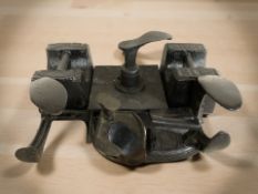 A group of cast iron cobbler's lasts and weights.