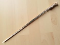 An African hardwood walking stick with figural pommel, length 91 cm.