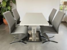 A contemporary glass topped rectangular dining table on chrome pedestal 120 cm x 70 cm x 77 cm