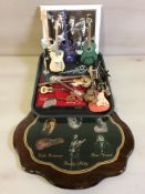 A group of miniature guitars and other instruments, a decorative plaque and print, etc.