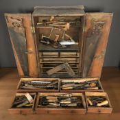 An early 20th century carpenter's double door toolbox and contents to include various hand tools,