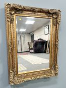 A 19th century style gilt and bevelled overmantel mirror, 89 cm x 120 cm.
