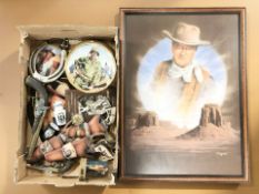 A group of John Wayne collectibles including revolvers, a large print, collector's plates,