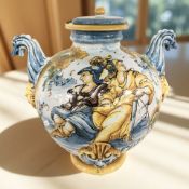 A reproduction Majolica twin-handled lidded urn with spout, height 43 cm.