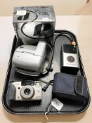 A Polaroid camera, a Minolta camera and a digital tire inflator.