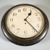 An early 20th century circular wall timepiece signed 'Enfield', diameter 40 cm.