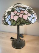 A Tiffany style patinated metal and stained glass mushroom table lamp, height 54 cm.