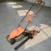 A Flymo lawnmower and a Black & Decker hedge trimmer.