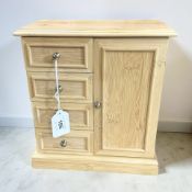 A beech effect four drawer jewellery box, with mirrored panel back, width 23 cm.