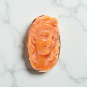 A coral cameo ring in white metal shank stamped 9ct, size H CONDITION REPORT: 6.