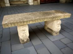 A weathered concrete rectangular garden bench, width 120 cm.