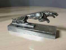 A chrome Jaguar car mascot paperweight, length 13 cm.