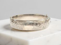 An engraved silver bangle, inner width 6cm CONDITION REPORT: 34.